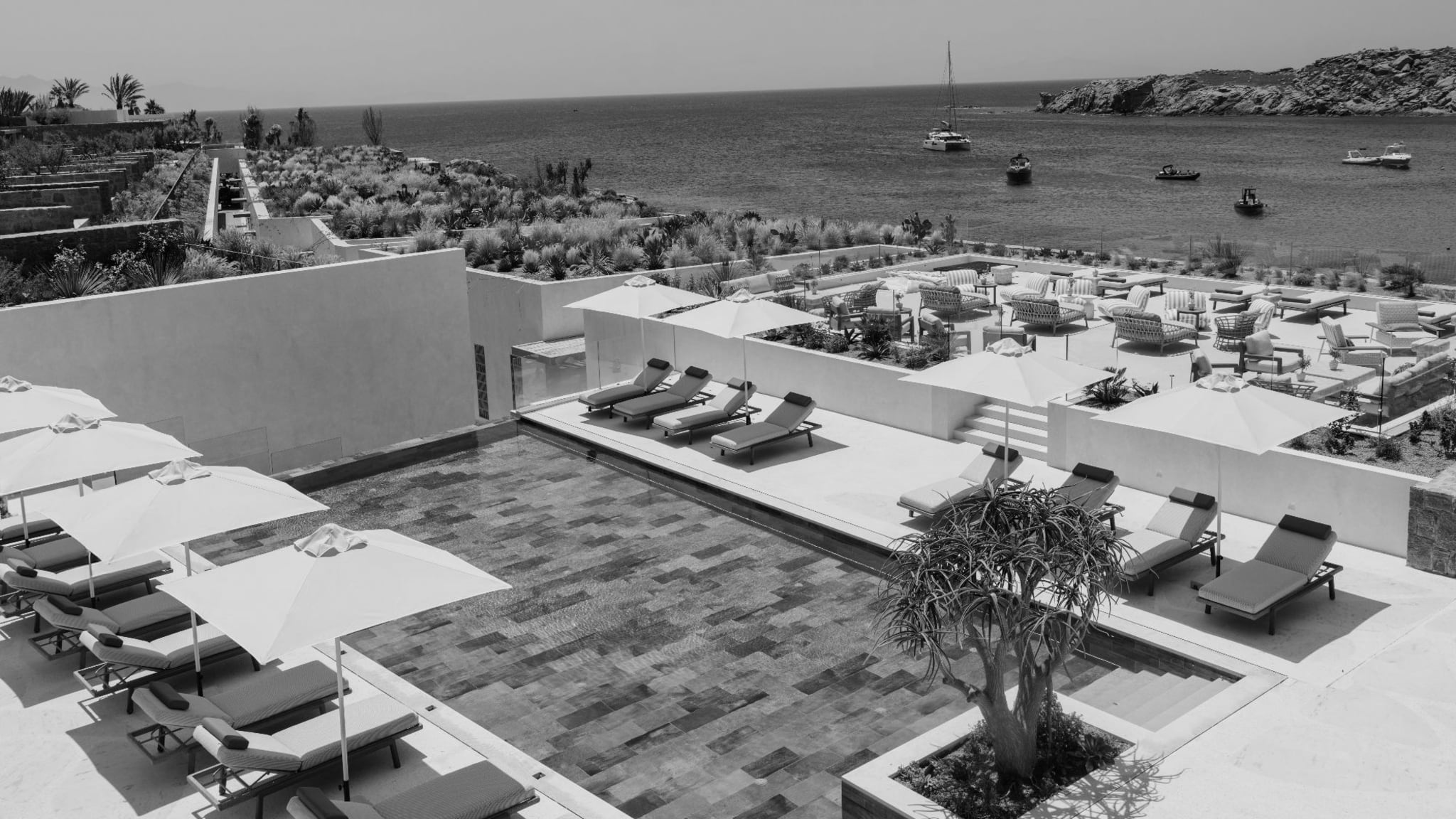 Aerial view of Fouquet’s Mykonos pool terraces and Paraga Beach on the Aegean coast