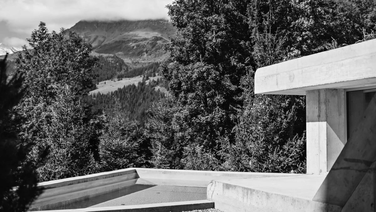 Outdoor pool at Grand Hotel Belvedere’s concrete spa overlooking the forested Bernese Alps in Wengen