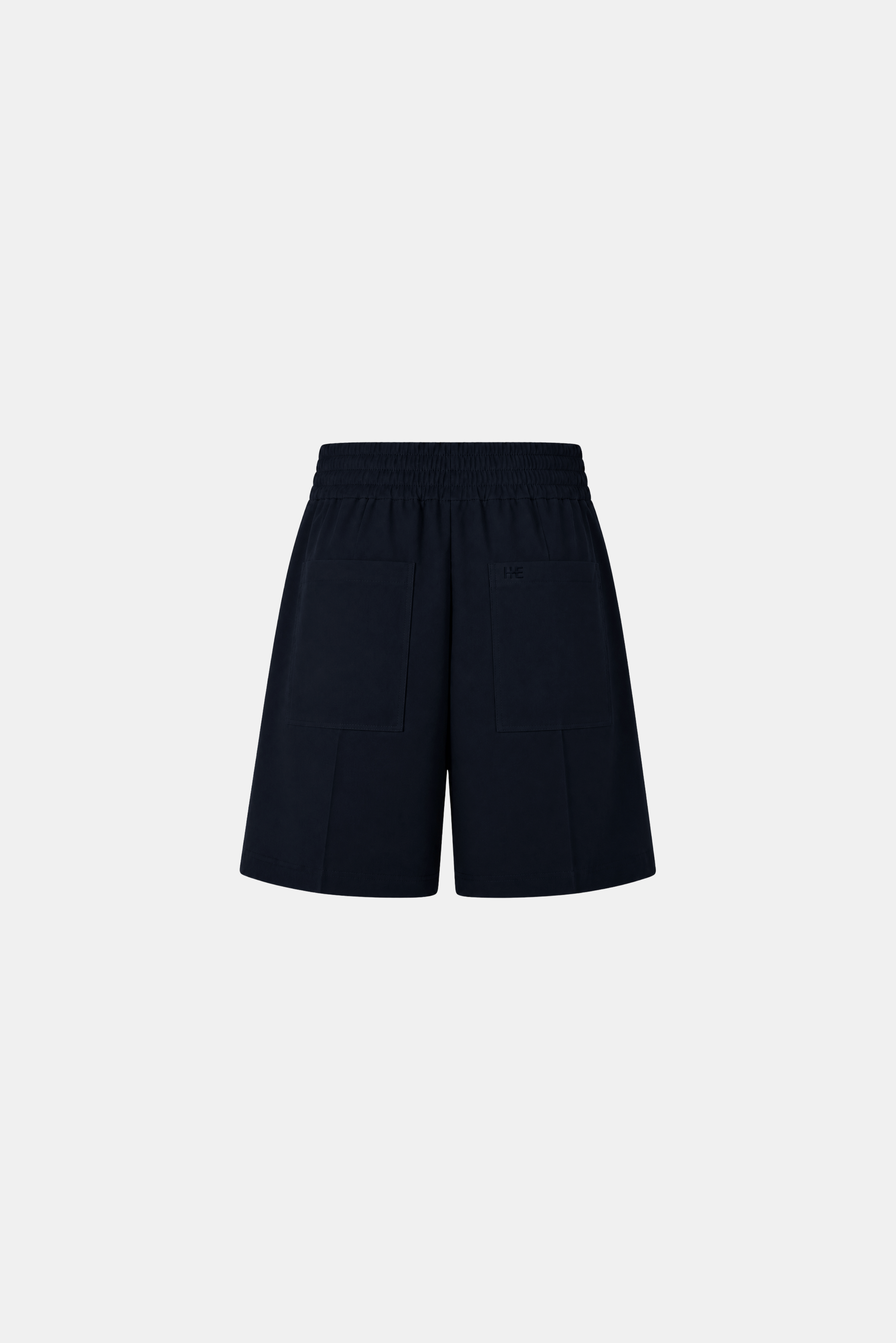 A pair of dark navy blue shorts with an elastic waistband and front patch pockets, shown flat against a light gray background.