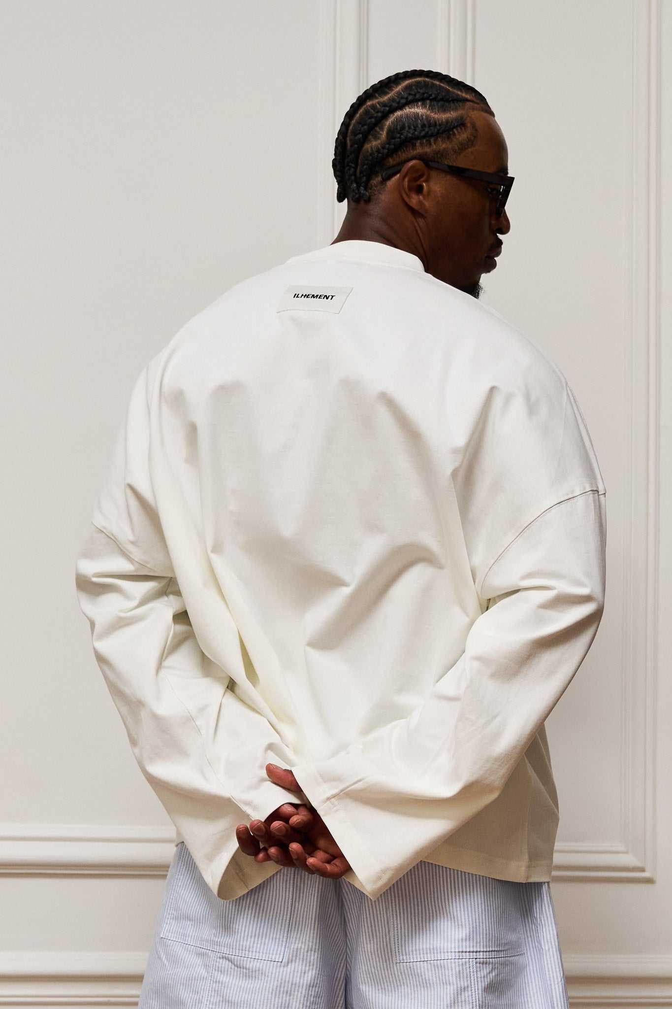 Cropped boxy long sleeve T-shirt with architectural seaming and tonal ILHEMENT logo print