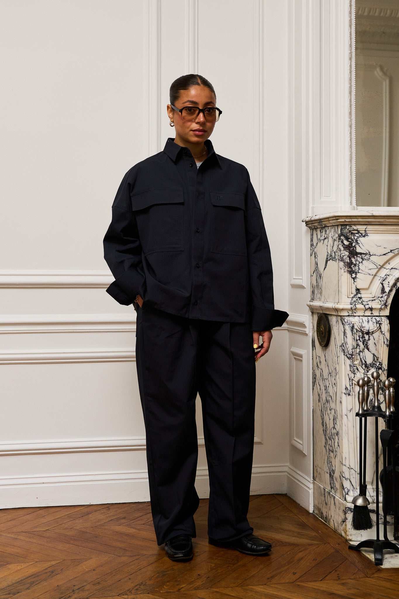 Navy pleated pants made from heavyweight organic ripstop cotton with oversized silhouette and stitched-down front pleats