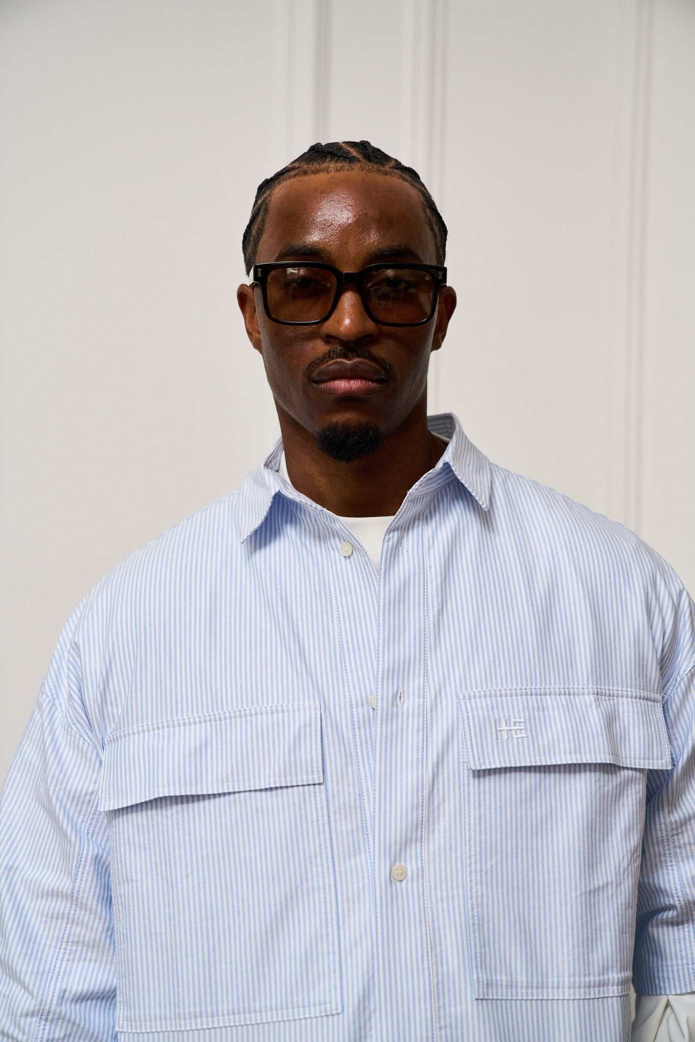 Short sleeve oversized striped organic cotton Oxford shirt showcasing subtle architectural design and versatile style