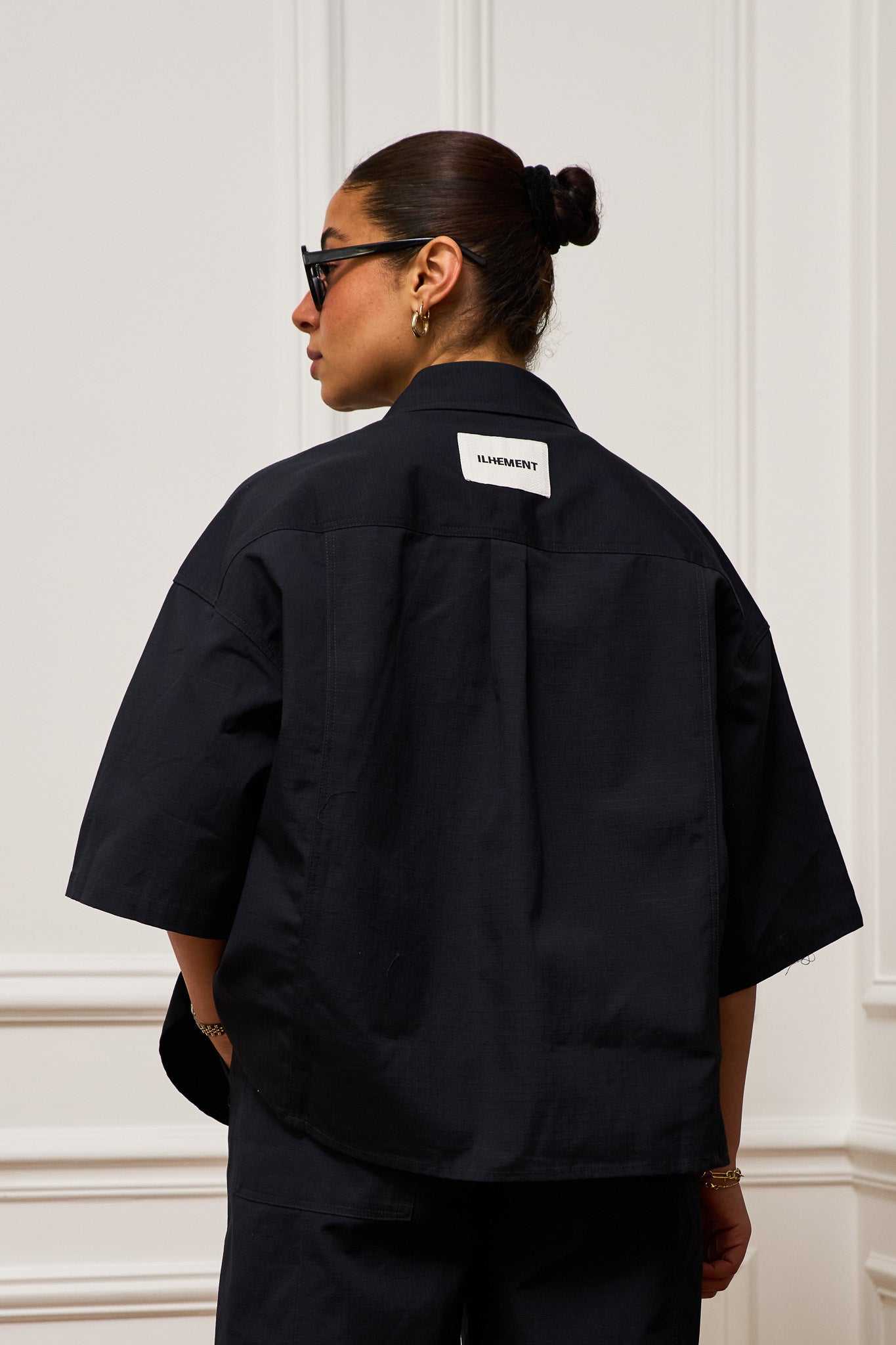 Oversized short sleeve ripstop shirt in structured organic cotton showcasing subtle architectural design and versatile style