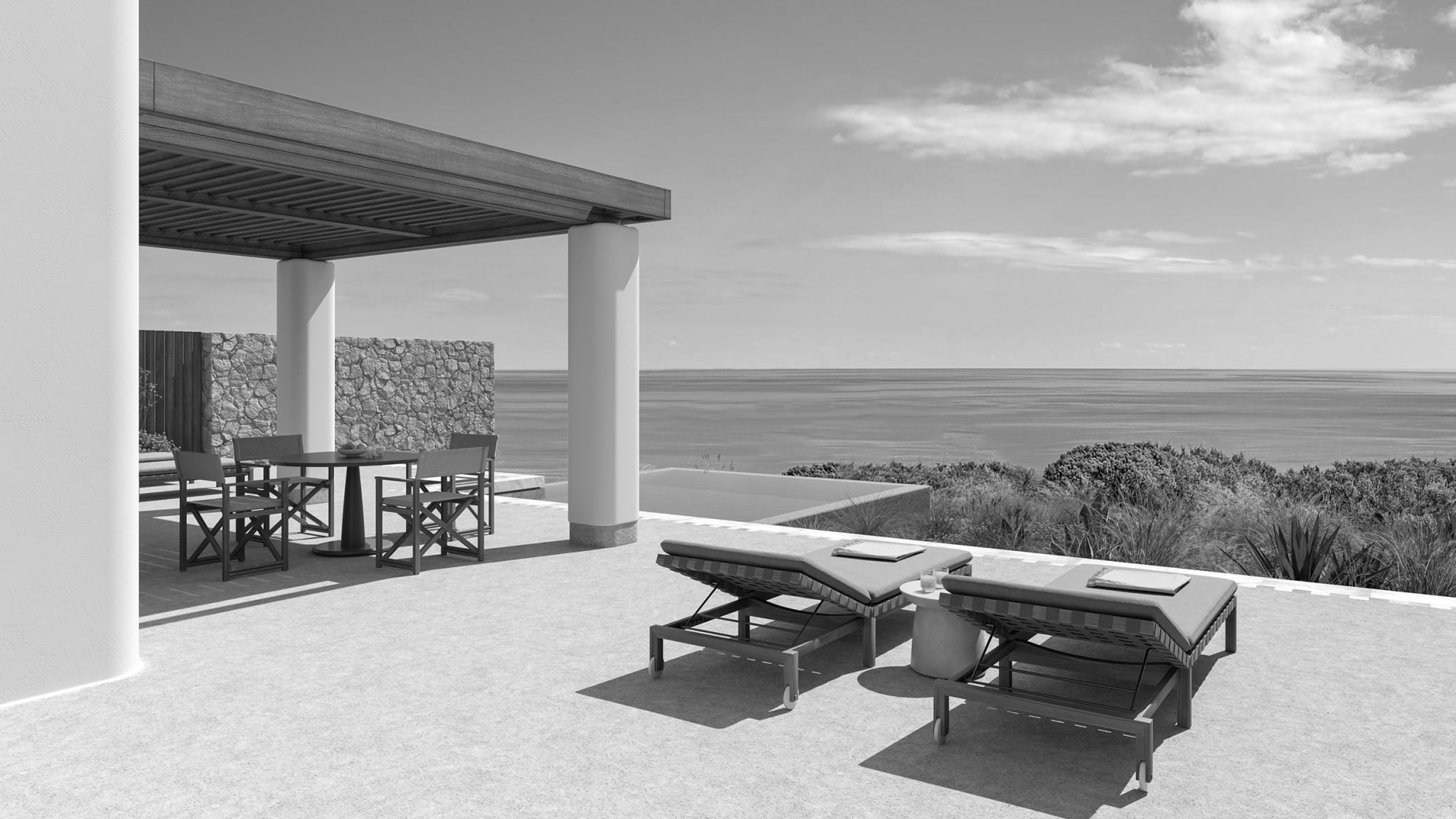 Sea-facing terrace at Eréma in Milos, with pale stone, shaded seating and open Aegean views.