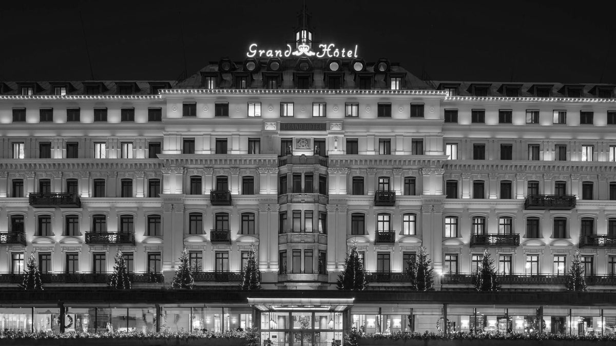 Illuminated façade of Grand Hôtel Stockholm facing the waterfront at night