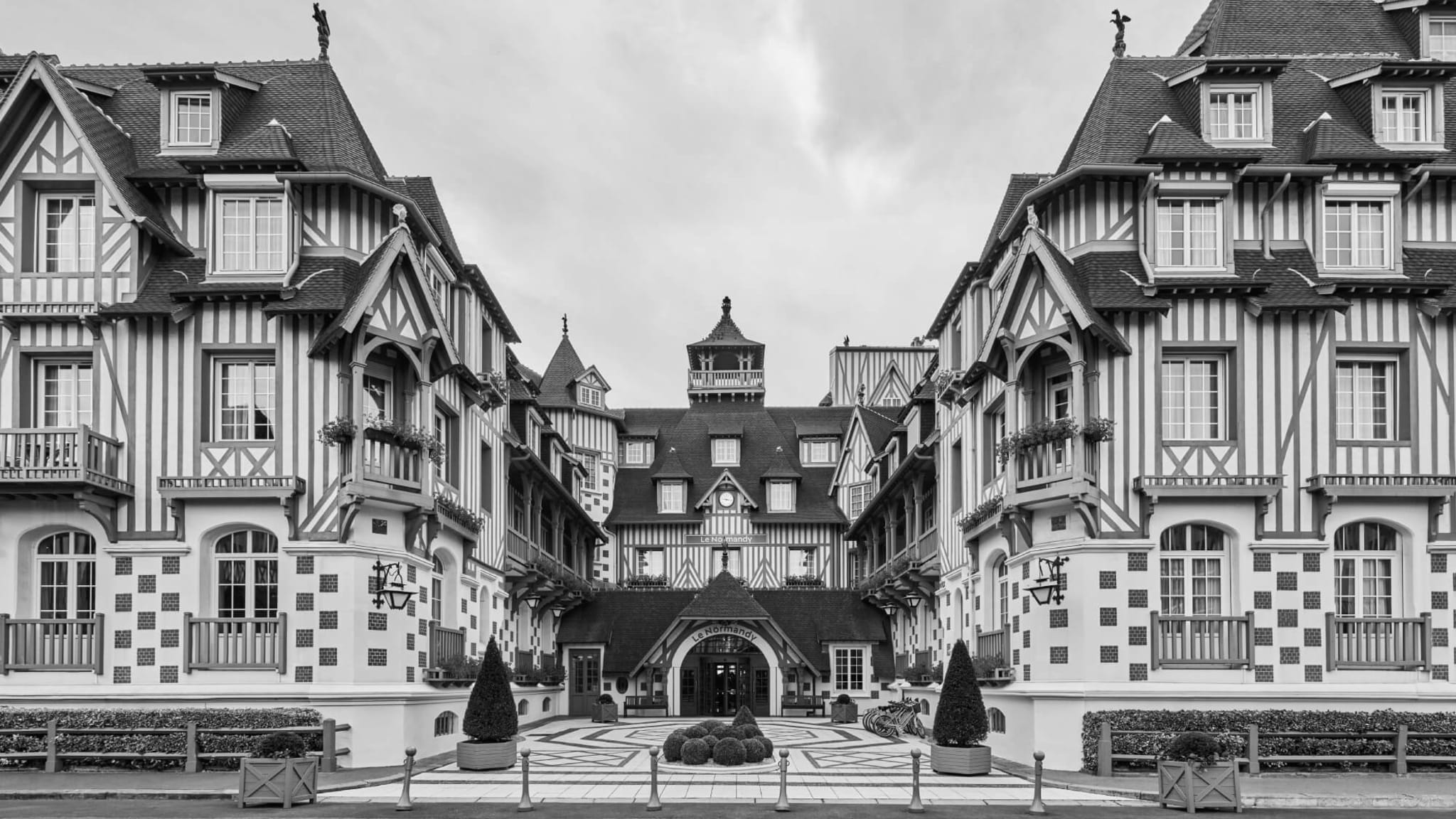 The half-timbered façade and steep roofline of Hôtel Barrière Le Normandy in Deauville, France.