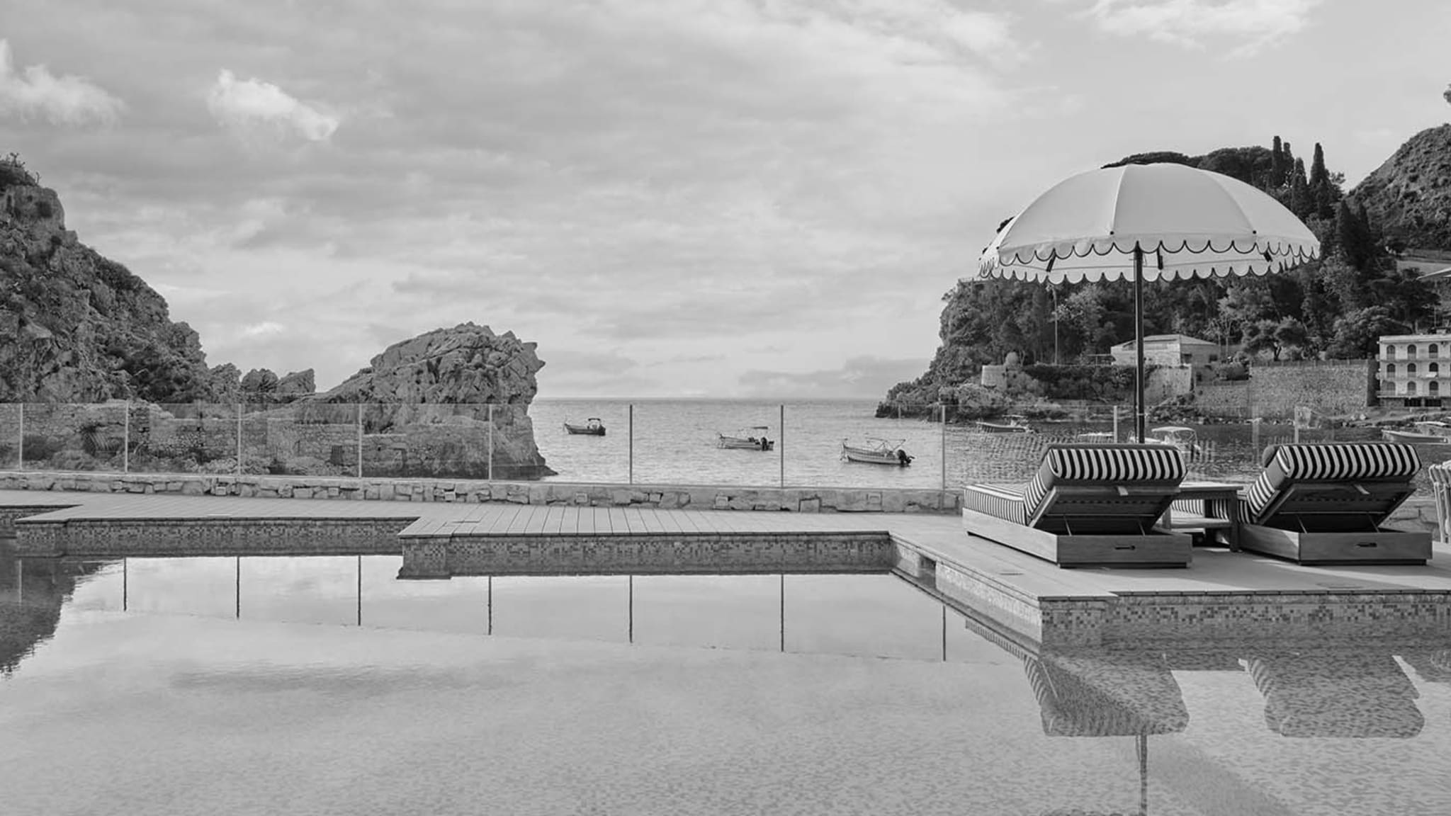 Mazzarò Sea Palace pool terrace overlooking the rocky Bay of Mazzarò in Taormina, Sicily