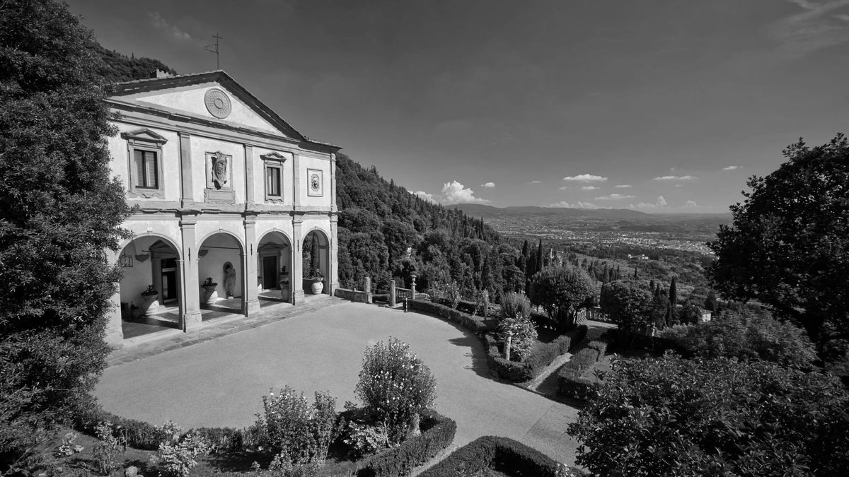 Villa San Michele façade and terraced gardens overlooking the Florentine landscape