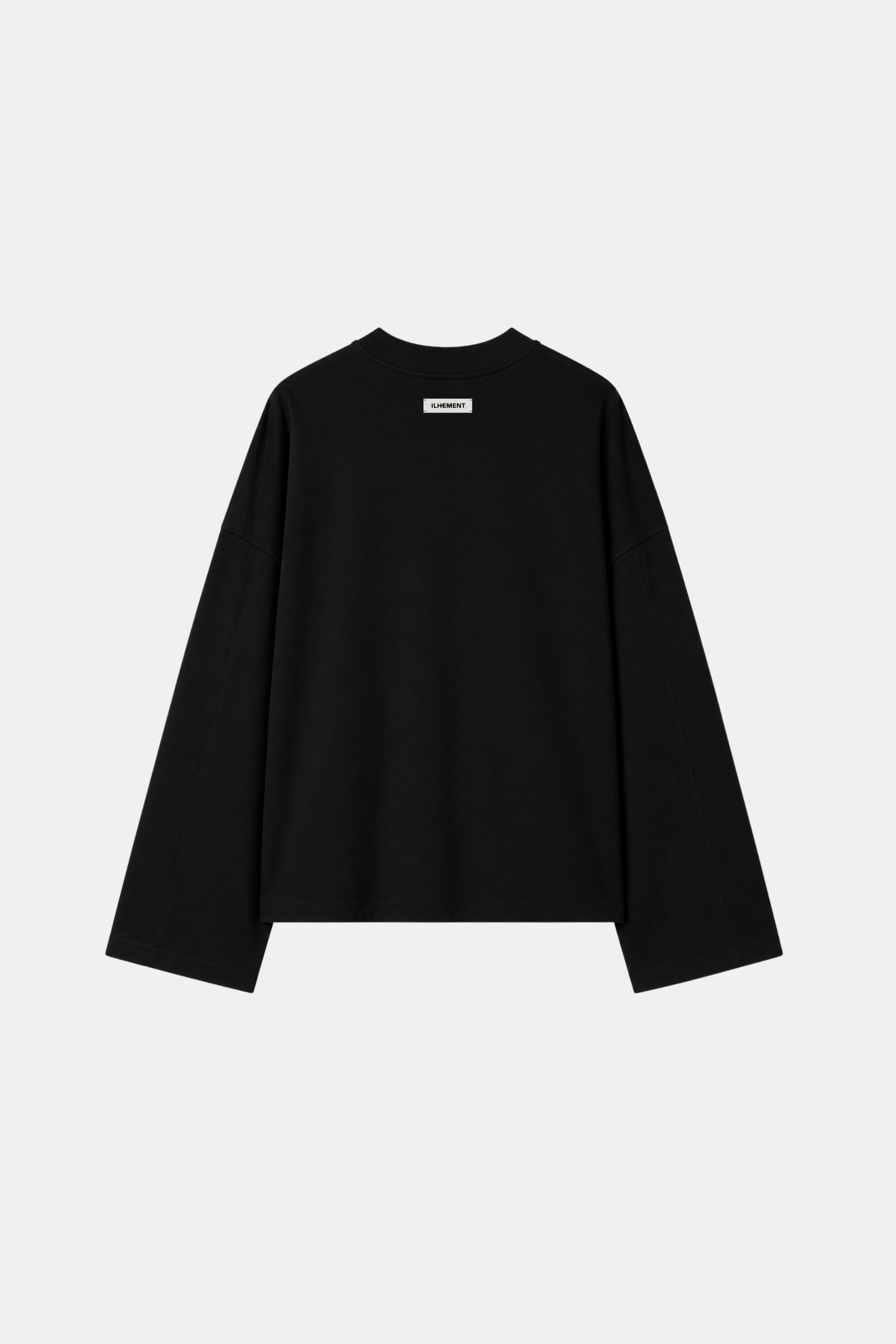 A black long-sleeve crewneck sweatshirt with a small white rectangular label on the chest, displayed against a light gray background.
