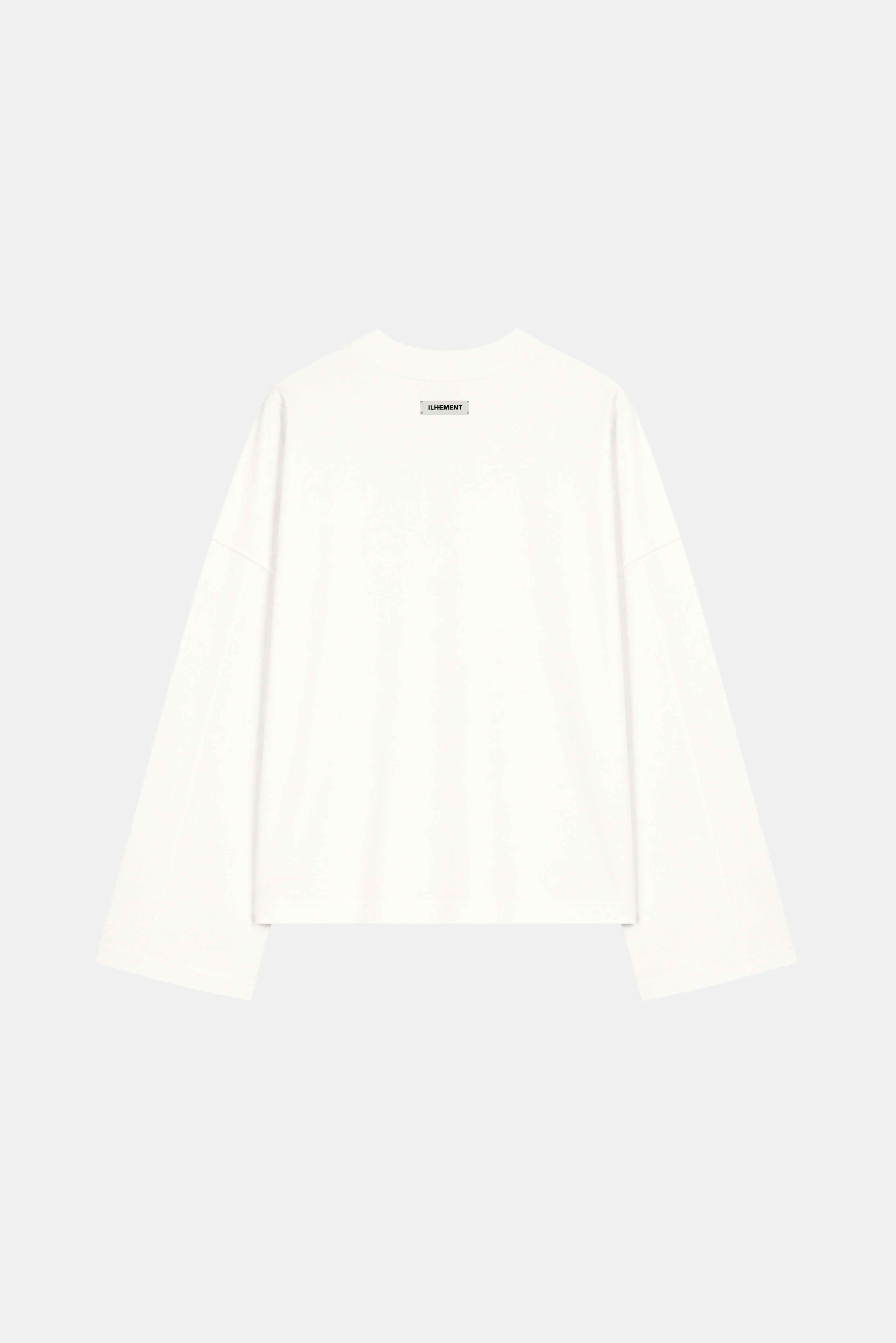 A white long-sleeve crewneck top shown from the back, featuring a small black graphic or text detail centered below the neckline, set against a solid light gray background.