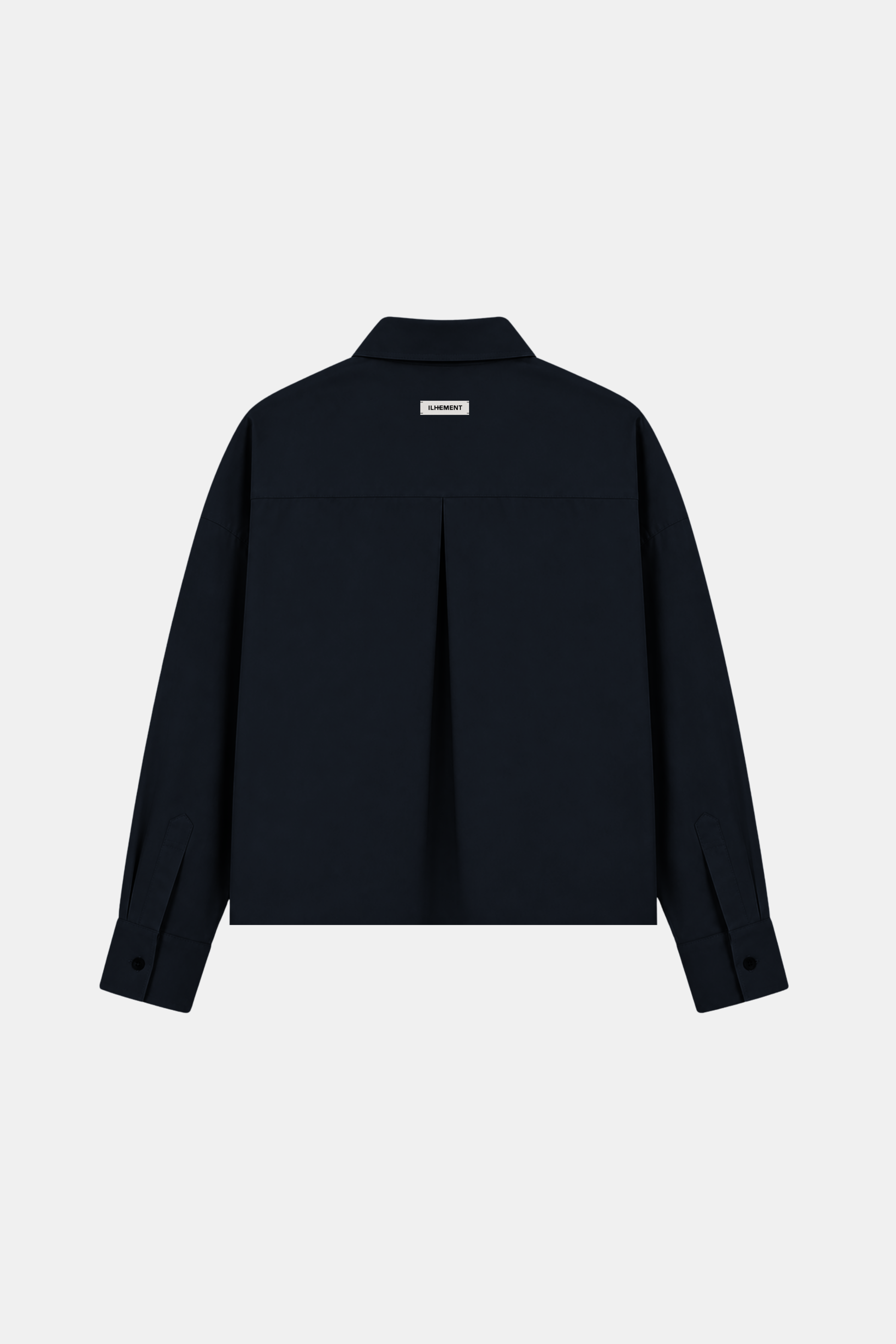 A dark navy blue long-sleeve button-up shirt jacket shown from the back, featuring a subtle vertical pleat detail at the center back and a small rectangular brand label near the collar, set against a solid light gray background.