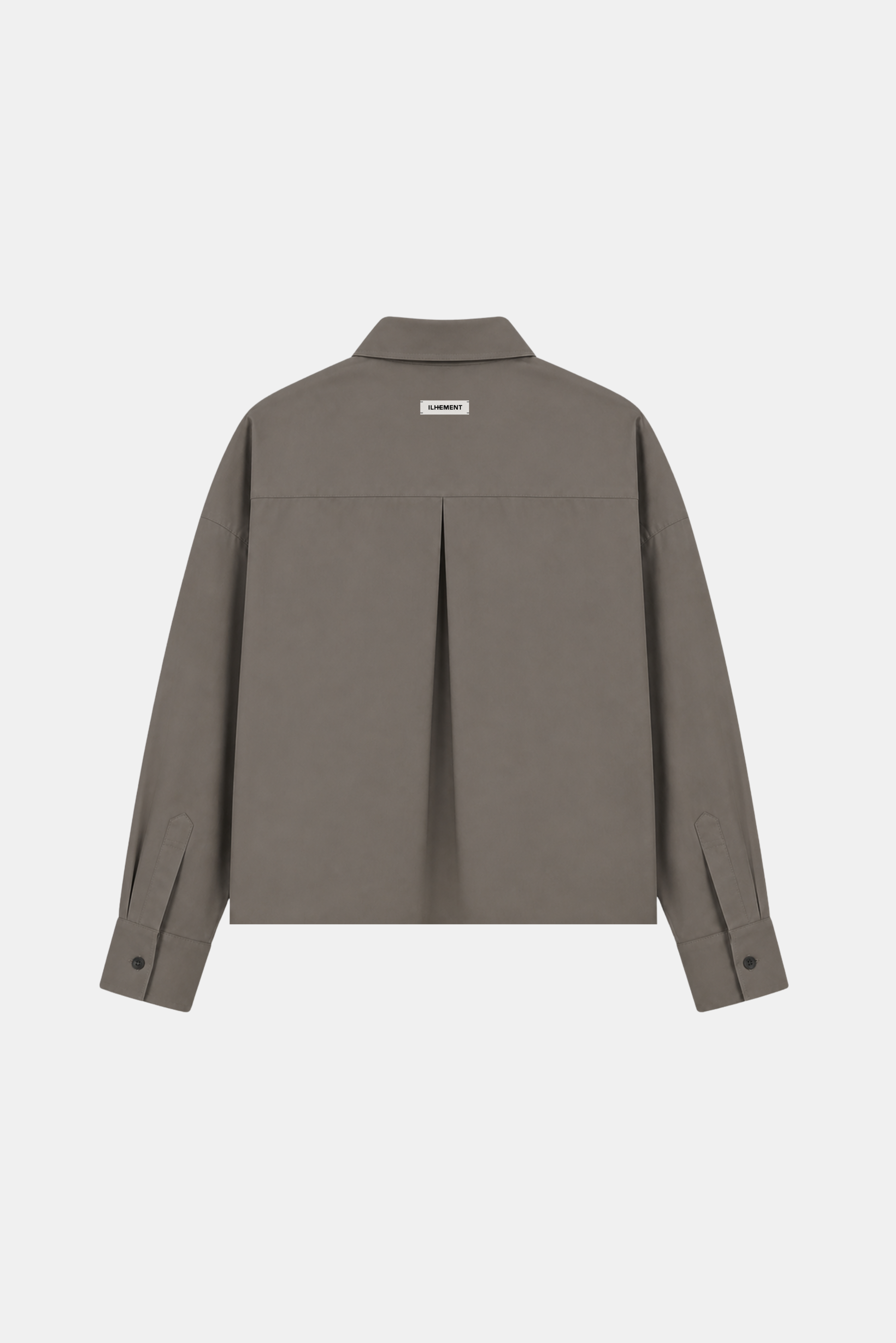 A taupe-brown long-sleeve button-up shirt jacket shown from the back, featuring a central pleat detail and a small rectangular brand label at the collar, set against a plain light gray background.