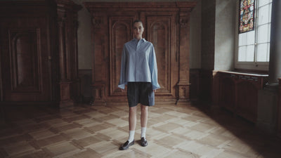 ILHEMENT Swiss resort wear and pyjamas campaign video featuring a woman in pleated boxer shorts and an oversized shirt.